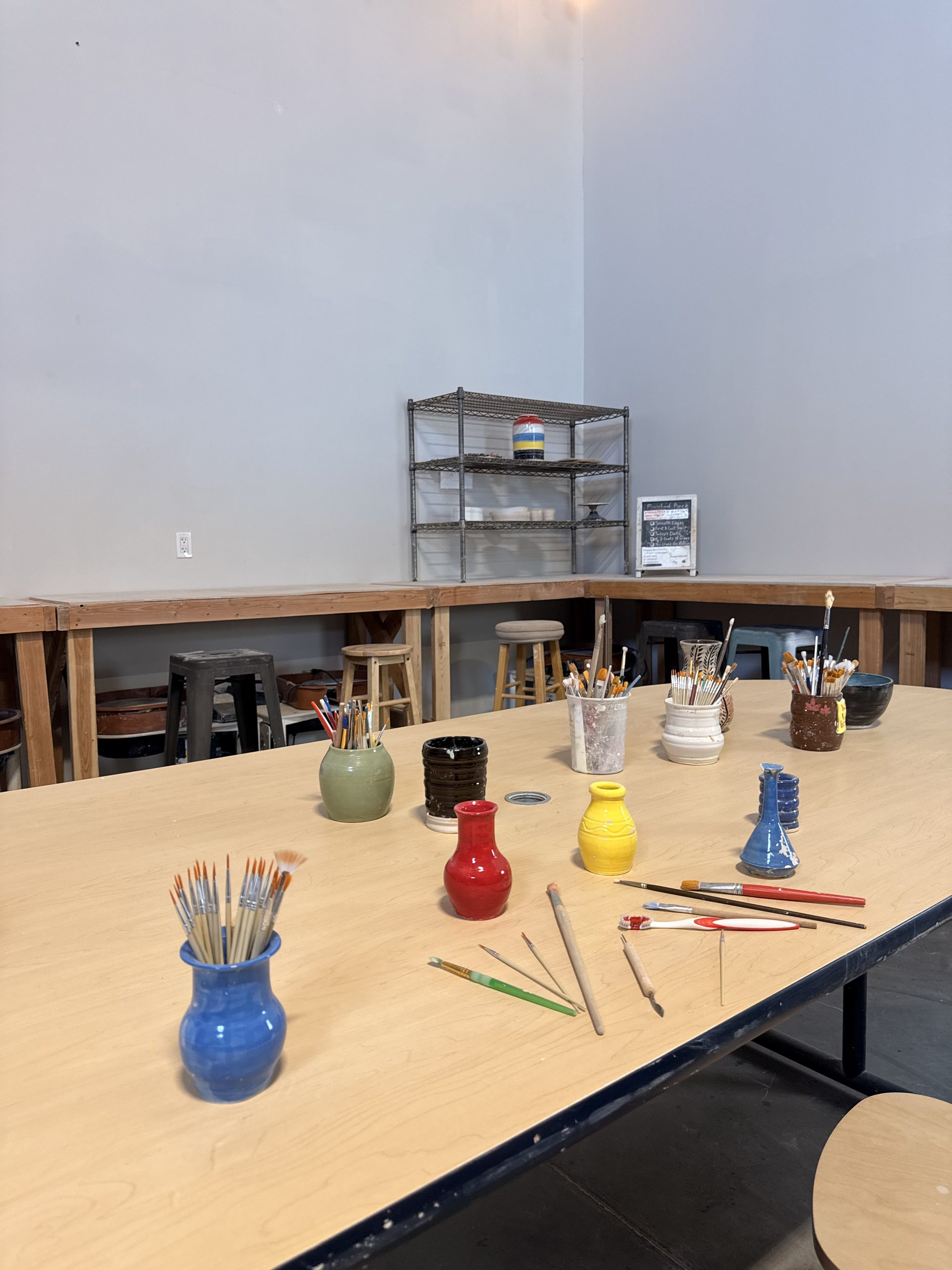 The painting table set with bisque pieces and brushes